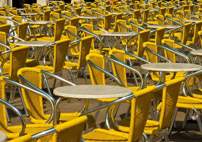 Yellow chairs and table at outdoor cafe