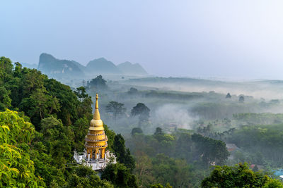 Aerial view of golden stupa or pagoda at khao na nai luang dharma park in surat thani thailand