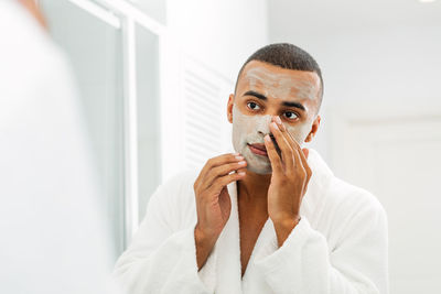 Portrait of young man in bathroom