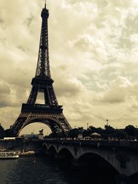 Low angle view of eiffel tower against cloudy sky