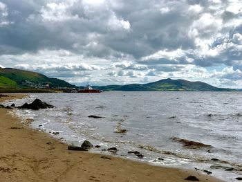 Scenic view of sea against cloudy sky