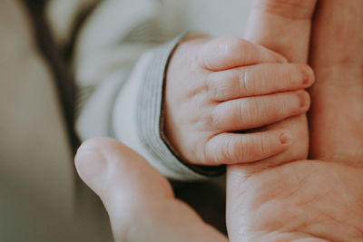 Close-up of baby holding finger