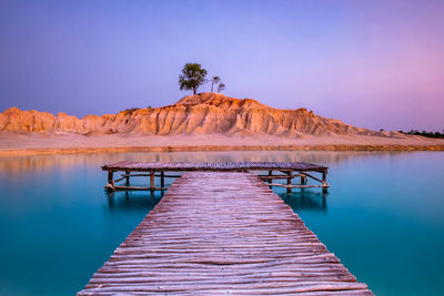 Pier over lake against sky