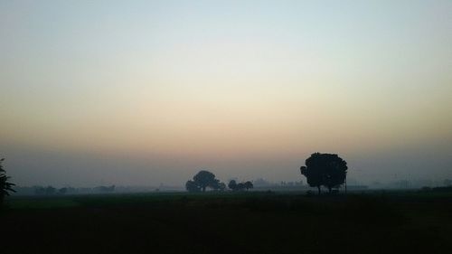 Scenic view of landscape against sky during foggy weather