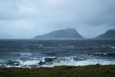 Scenic view of sea against cloudy sky