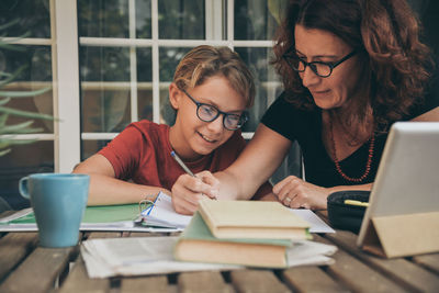 Boy with mother studying at home