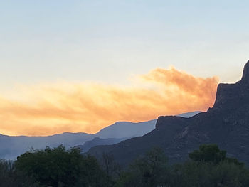 Scenic view of silhouette mountains against sky during sunset