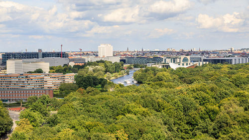 High angle view of buildings and trees against sky