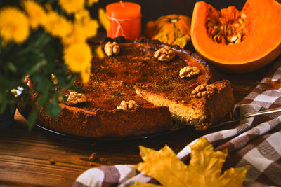 Traditional pumpkin pie with walnuts and ingredients