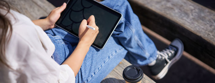 Midsection of man using mobile phone