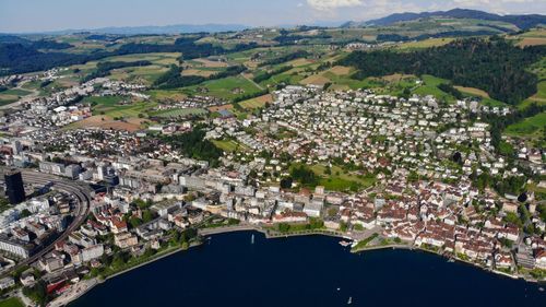 Aerial view of river amidst buildings in town