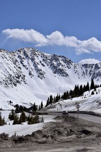 Scenic view of snow covered mountains against sky