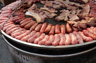 High angle view of various meats on barbecue grill