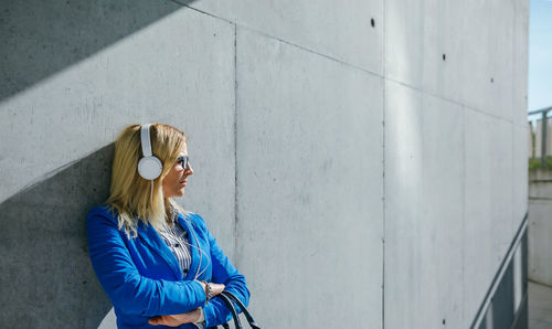 Woman standing against wall