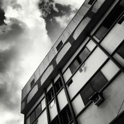 Low angle view of building against cloudy sky