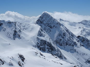 Scenic view of snow covered mountains against sky