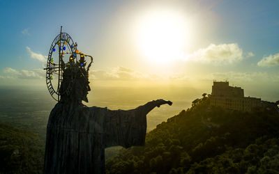 Low angle view of statue at sunset