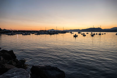 View of boats in marina at sunset