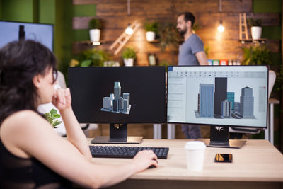 Businesswoman using laptop at table