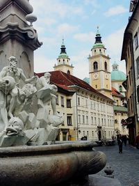 Statue in temple against sky in city