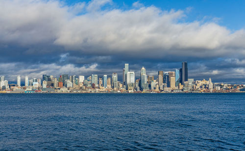Billowing clouds hover over the seattle skyline.
