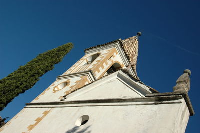 Low angle view of church against blue sky