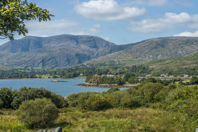 Scenic view of lake and mountains against sky