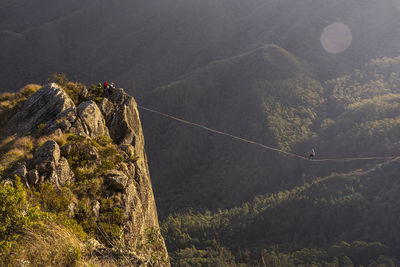 Beautiful view to adventure highliner on mountain with green forest