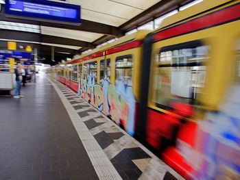 Blurred motion of train at railroad station