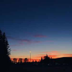 Silhouette trees against sky during sunset