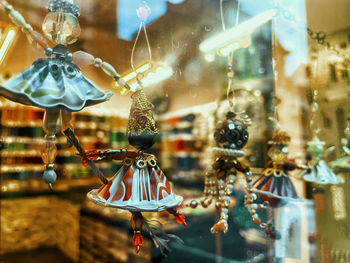 Close-up of glass for sale at store. figurines. 