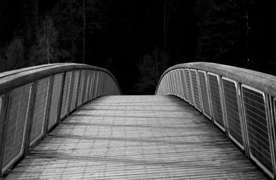 Empty footbridge along trees