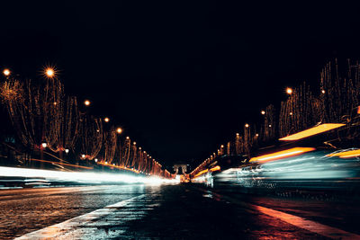 Illuminated light trails on road at night