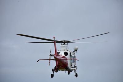 Low angle view of helicopter against clear sky