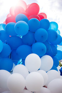 Low angle view of balloons against blue sky