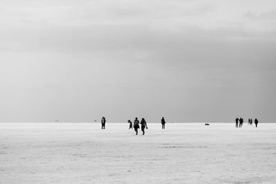 People on beach against sky