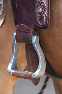 Close-up of metal hanging on wood