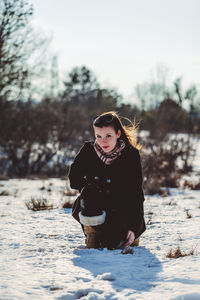 Portrait of young woman on snow covered land