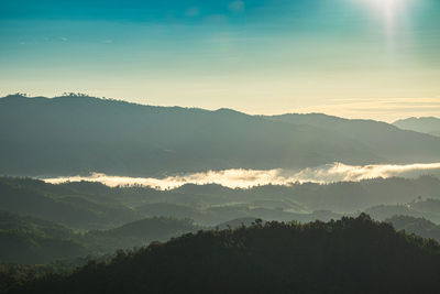 Scenic view of silhouette mountains against sky during sunset