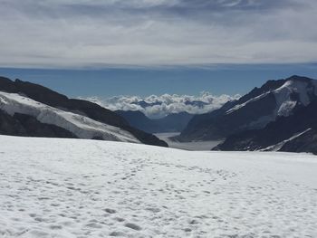 Scenic view of snow covered mountains against sky