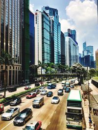 Cars on road in city against sky