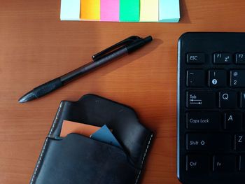 High angle view of pen and keyboard on table