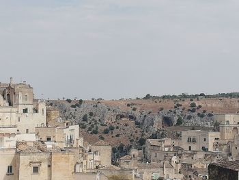 Buildings in city against clear sky