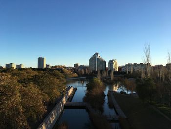 View of cityscape against clear blue sky