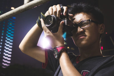 Portrait of young man photographing