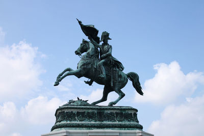 Low angle view of statue against sky