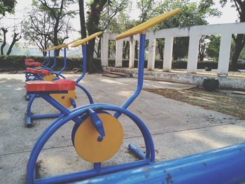 Empty playground against trees in park