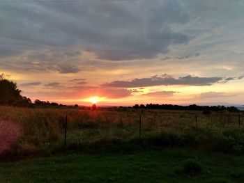 Scenic view of field against sky during sunset