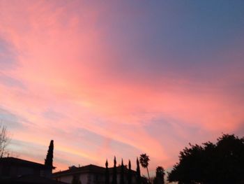 Low angle view of built structure against sky at sunset