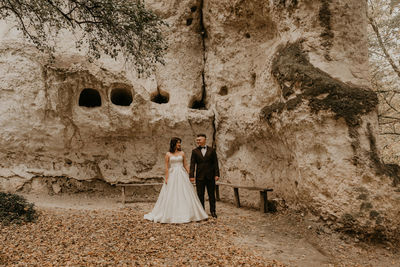 Rear view of woman standing in cave